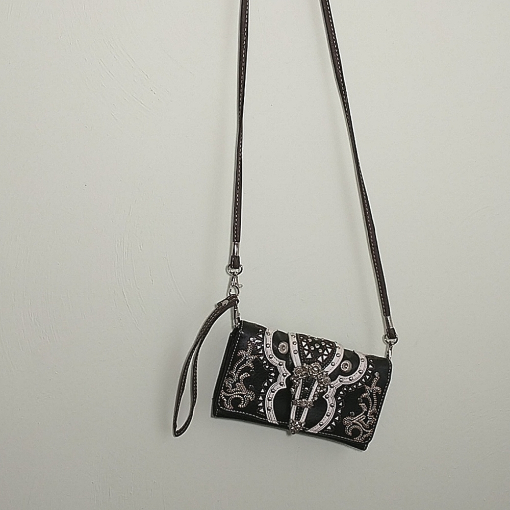 Unbranded, tri-fold clutch with crossbody strap.
